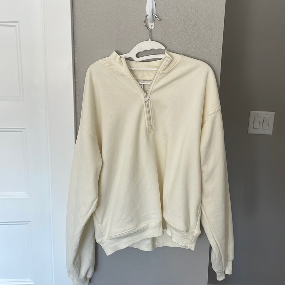 This is a cream zip up crew neck from Fabletics! It's a gently used!